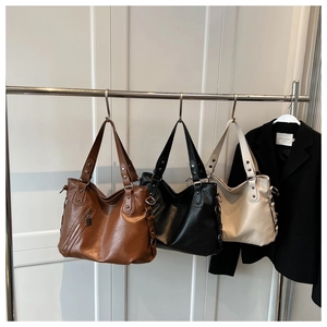 Detailed view of large tote bags in brown black and white with荔枝纹 grain leather texture