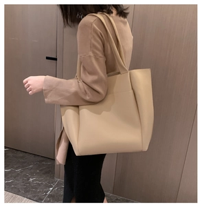 Minimalist beige PU leather tote bag shown on a model for casual commuting style