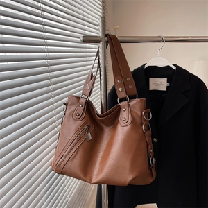 Minimalist brown faux leather large tote bag with zipper pocket and metal rivets details