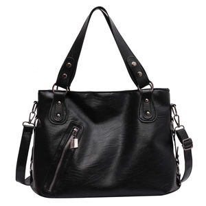 Minimalist black PU leather tote bag with silver zipper detail and adjustable straps
