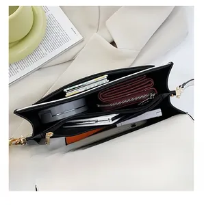 Detailed interior of color-block crossbody bag showing spacious main compartment and zip pocket
