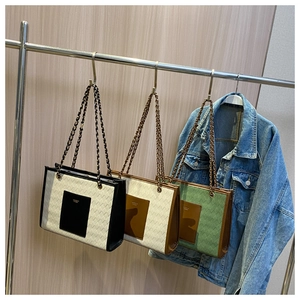 Trois sacs cabas tissés avec bandoulières en chaîne métallique sur un cintre de style rustique