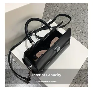 Detail view of the black crossbody bag's interior capacity with makeup items