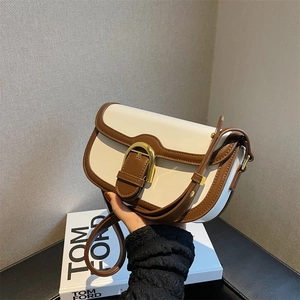 Vintage two-tone saddle bag in cream and brown with golden horsebit buckle detail