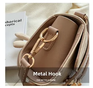 Close-up of high-quality gold metal hardware hook on a stylish leather handbag