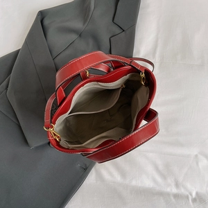 Top view of red leather tote bag showing interior compartments and gold hardware