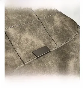 Macro shot of matte suede texture with square quilting and gunmetal buckle detail
