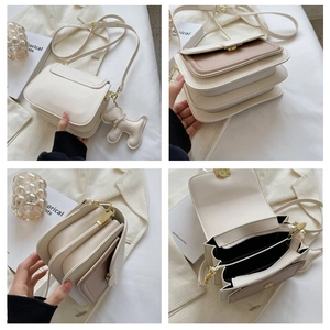 Detail view showing multi-layer compartments and gold clasp of the beige crossbody bag