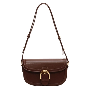 Retro dark brown leather saddle bag with gold D-buckle and adjustable strap on white background