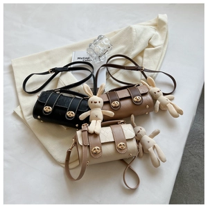 Detailed view of quilted leather crossbody bags in black, caramel, and beige with rabbit charms