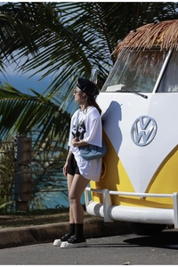 Close-up of oversized white T-shirt featuring a cartoon print in an outdoor street setting