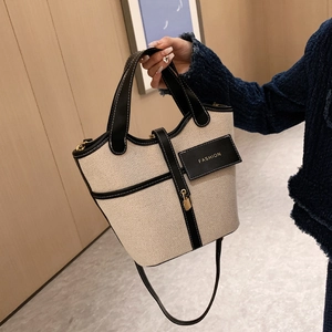 Canvas bucket bag with black leather trim, double handles and fashion tag detail