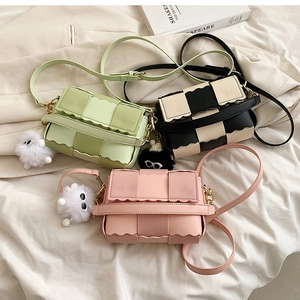 Chic woven crossbody bags with scalloped edges and cute plush charms in three colors