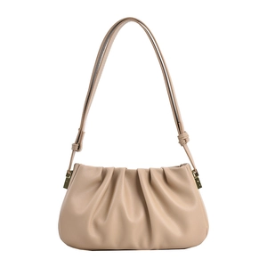 Elegant beige pleated cloud shoulder bag in soft leather with golden buckles on white background