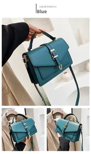 Detail of teal leather mini square bag with golden buckle and detachable strap