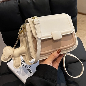 Minimalist beige and brown leather crossbody bag with cute dog charm for women