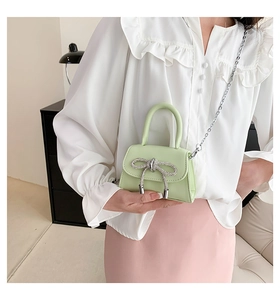 Mini light green crossbody bag with sparkling rhinestone bow and silver chain strap