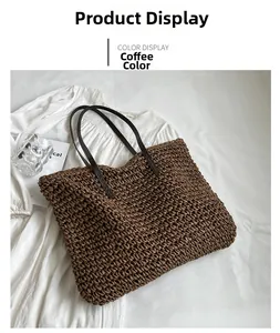 Coffee brown woven straw tote bag with long leather handles on a white linen shirt