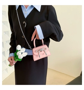 Pink PU leather handbag with sparkling silver rhinestone bow and metal chain strap detail