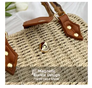 Detail of the magnetic snap closure and woven texture on a straw handbag