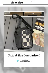 Detail showing the internal storage capacity of the black crossbody bag with a phone