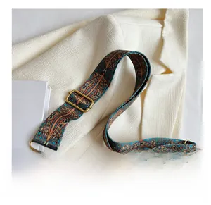 Detail of bohemian geometric pattern strap with vintage bronze buckle on leather tote bag