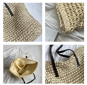 Detail of straw tote bag showing woven texture, zipper closure and inner pocket