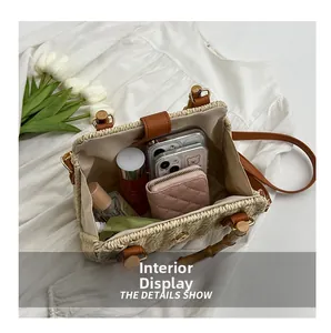 Top view of woven straw bag interior showing large capacity for phones and wallet