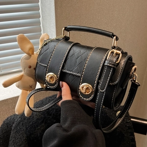 Classic black leather crossbody bag with quilted patterns and a cute beige bunny charm