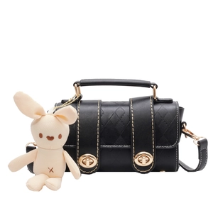 Mini black quilted leather handbag with gold twist locks and cute white bunny charm