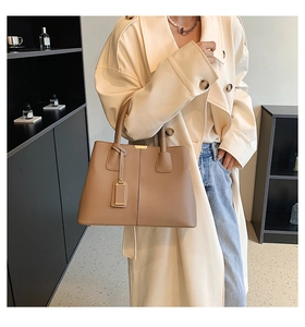 Brown lychee leather tote bag for women showing spacious capacity and stylish round handle
