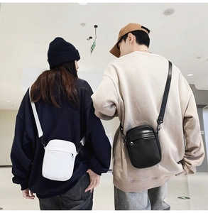 Detailed view of minimalist black and white PU leather crossbody bags with top zipper