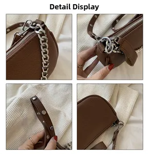 Detail view of brown pebbled leather bag featuring silver rivets and chunky chain strap
