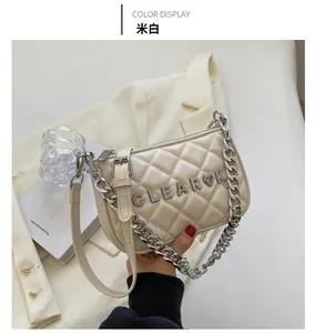 Detail of quilted beige crossbody bag with silver chunky chain and CLEAROK metal logo