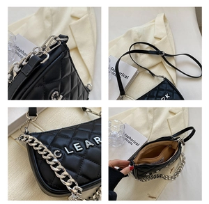 Detail of quilted leather bag featuring rhinestone CLEAR letters and silver chain strap