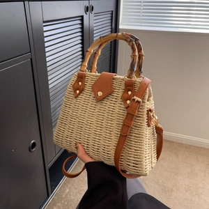 Handwoven straw tote bag with bamboo handle and brown leather trim detailing