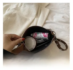 Spacious interior of dark brown leather handbag with silver rivets and zipper pockets
