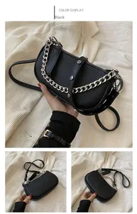Close-up of black rivet leather shoulder bag with silver chain and litchi texture details