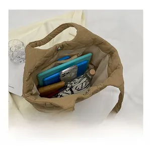 Interior view showing large capacity and zipper pocket of the khaki quilted tote bag