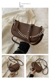 Detail of coffee brown retro shoulder bag with silver chain and rivet leather strap