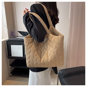 Detail of wave quilted stitching and soft padded texture on the large khaki tote bag