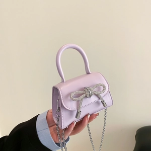 Lavender mini crossbody bag with rhinestone bow and silver chain strap for women
