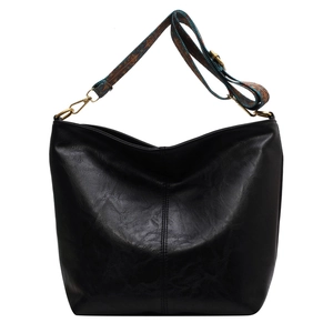 Large black leather tote bag with colorful bohemian strap and glossy pebble texture