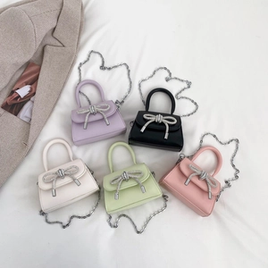 Mini handbags with rhinestone bows in purple, black, white, green and pink colors