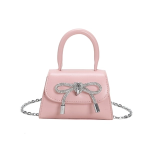 Pink mini handbag with large silver rhinestone bow and elegant metal chain strap