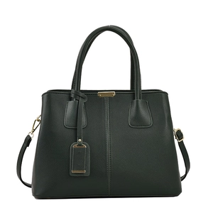 Close-up of deep green pebbled leather handbag with gold-tone hardware and crossbody strap