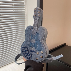 Unique guitar-shaped crossbody bag made of blue denim with metal studs and wide strap