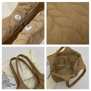 Detail view of khaki wave quilted tote bag featuring magnetic closure and inner pocket