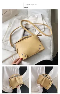 Detail view of a yellow rivet crossbody bag with a focus on its PU leather texture and strap