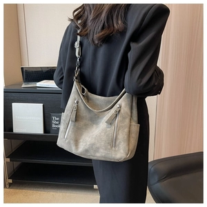 Detailed view of grey vintage tote bag with vertical zippers and adjustable strap